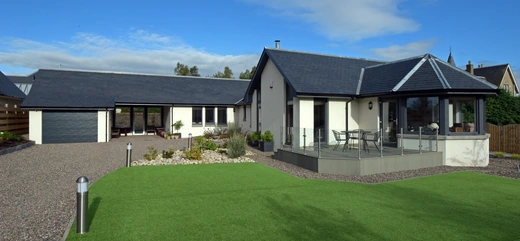 Roofing specialists working on tiled roof in Fife